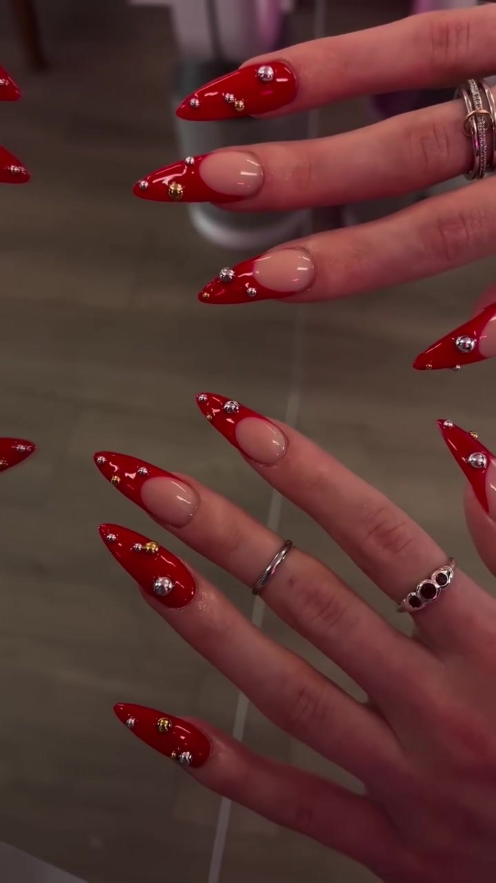 Glossy red stiletto set with gold and silver studs by Nailed By Yvonne